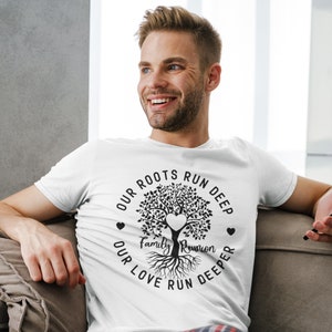 May include: White t-shirt with a black tree design and the text "Our roots run deep, our love run deeper, Family Reunion".