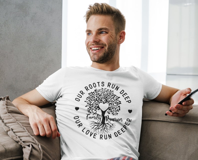 May include: White t-shirt with a black tree design and the text "Our roots run deep, our love run deeper, Family Reunion".