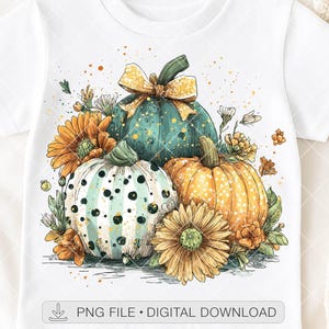 May include: White t-shirt featuring a watercolor design of three pumpkins in teal, white, and orange, surrounded by sunflowers and foliage. The pumpkins have green stems and are decorated with a yellow bow. Text at the bottom reads "PNG FILE • DIGITAL DOWNLOAD".
