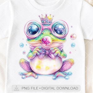 May include: White t-shirt featuring a whimsical frog illustration. The frog is adorned with a crown, glasses, and a bow tie, rendered in vibrant rainbow hues. Bubbles float around the frog. The text "PNG FILE • DIGITAL DOWNLOAD" is at the bottom.