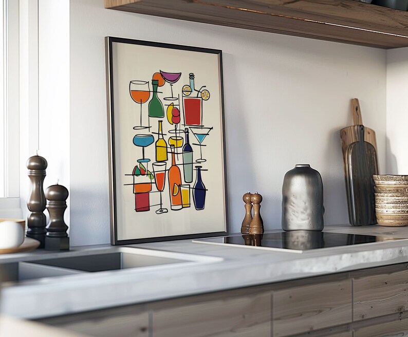 May include: A framed print of a colorful abstract illustration of various glasses and bottles of alcohol. The print is hanging on a white wall in a kitchen.