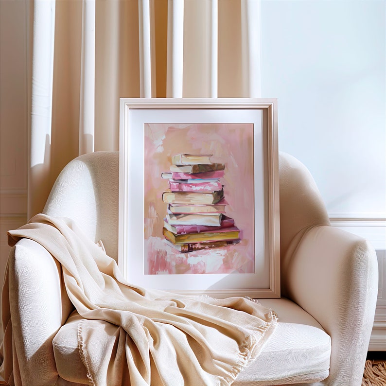 May include: A framed painting of a stack of books in various shades of pink, beige, and brown. The books are arranged in a pile on a pink background with a white frame.