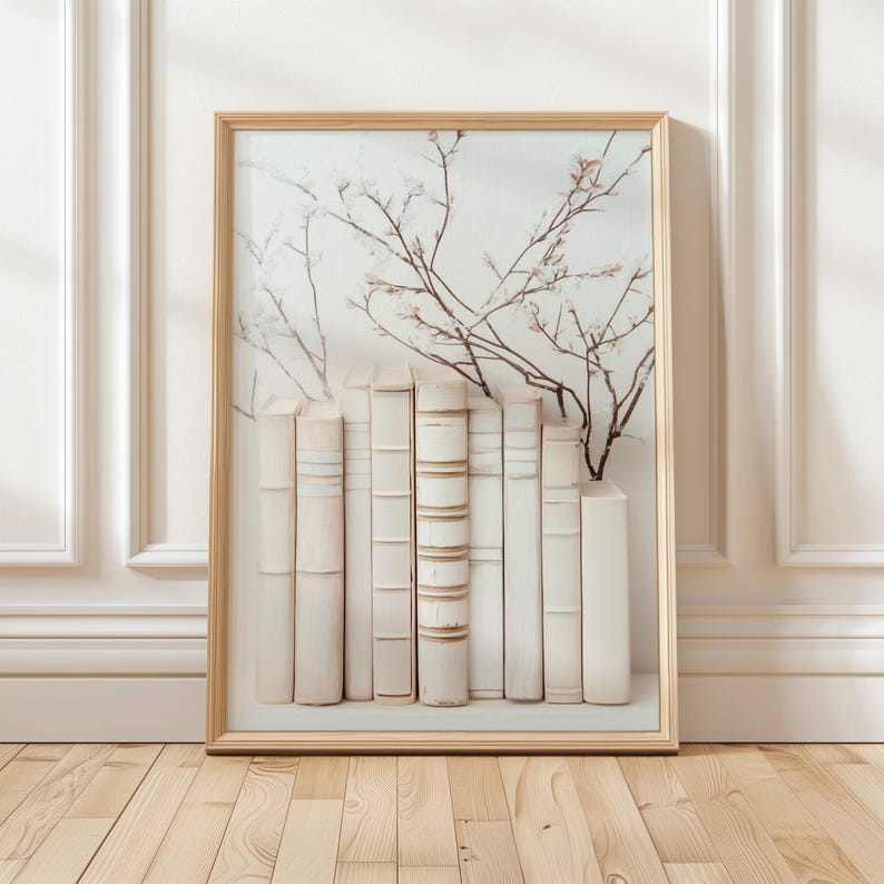 May include: A framed print of a white bookshelf with a row of antique books and a delicate floral arrangement in the background.