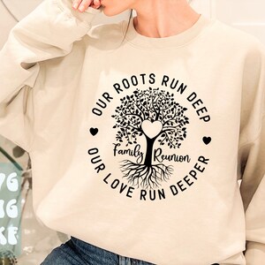 May include: A beige sweatshirt with a black graphic of a tree with roots and the text "Our roots run deep, Our love run deeper, Family Reunion".