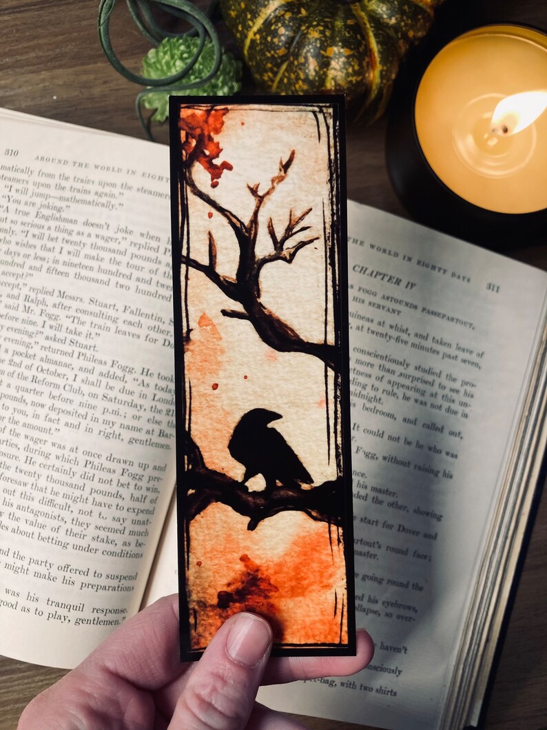 May include: A black crow perched on a branch of a tree with orange and red watercolor accents. The background is a light beige with a black border. The text "Chapter IV" is visible in the upper right corner.