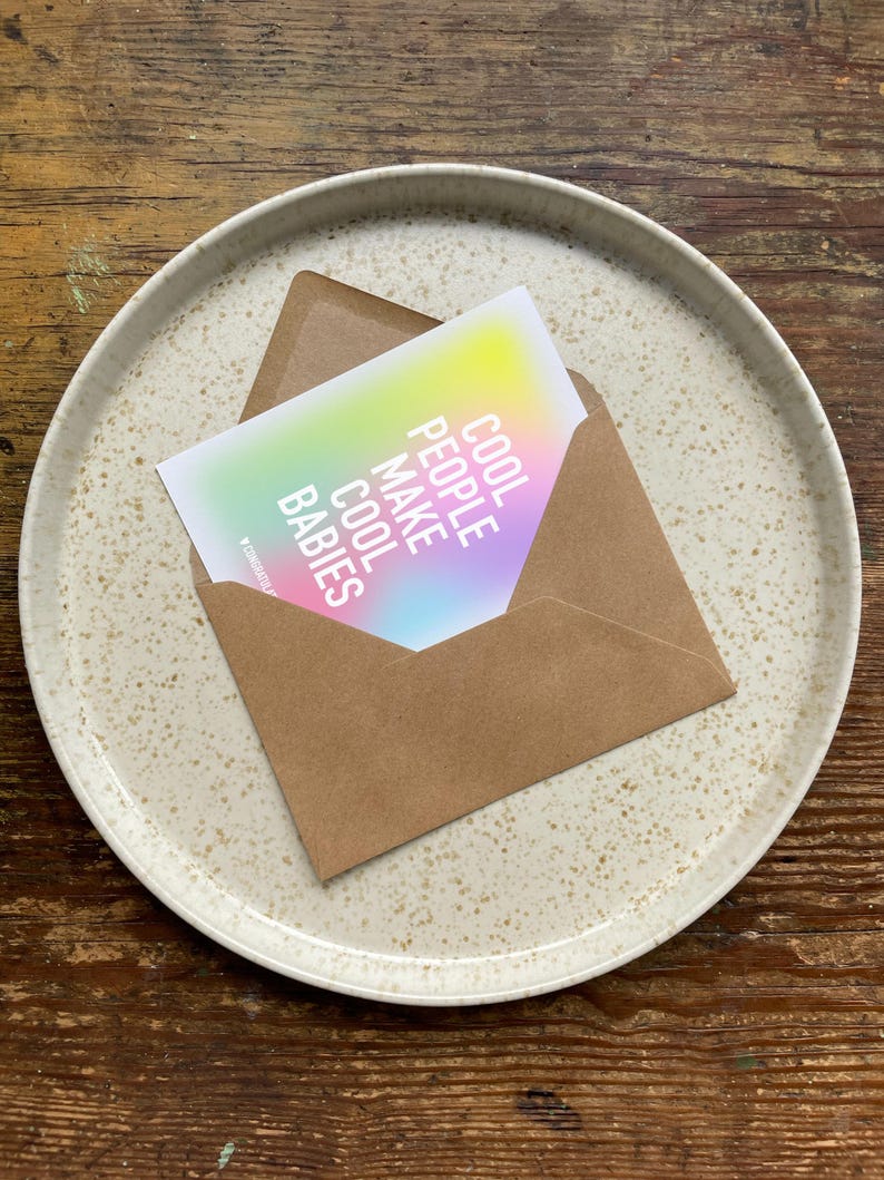 May include: A card with a rainbow gradient background and the text "Cool People Make Cool Babies" in white.