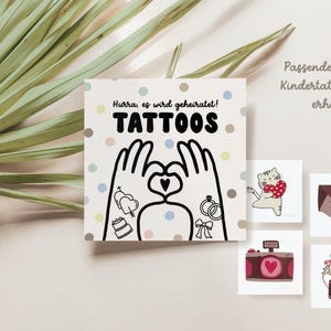 May include: A set of temporary tattoos with a wedding theme. The tattoos feature a couple holding hands with a heart, a wedding cake, a ring, and a bouquet of flowers. The text on the card reads "Hurray, we're getting married! Tattoos".