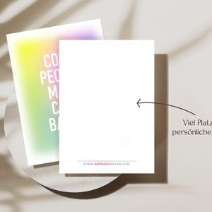 May include: A blank card with a rainbow gradient background and the text "CO PE M C B" on the left side. The card is on a white surface with a shadow. The text "Viel Platz f&uuml;r pers&ouml;nliche Worte" is on the right side of the image.