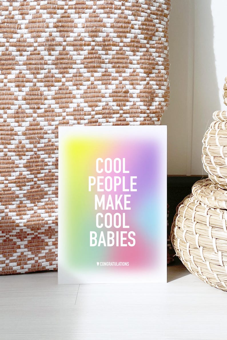 May include: A rainbow gradient card with the text "Cool People Make Cool Babies" in white. The card has a small heart and the word "Congratulations" in white at the bottom.