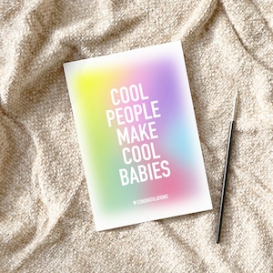 May include: A rainbow gradient card with the text "Cool People Make Cool Babies" in white. The card has a small heart with the word "Congratulations" below the text.