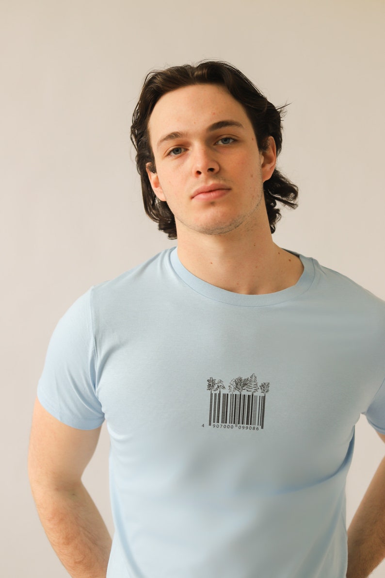 May include: A light blue t-shirt with a black and white barcode graphic of trees. The barcode reads "4 907000 099086".
