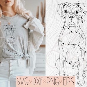 May include: A light gray t-shirt featuring a line drawing of a Boxer dog wrapped in Christmas lights. The dog is sitting upright. The bottom of the image includes the text "SVG, DXF, PNG, EPS".