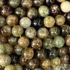 May include: A strand of green and brown gemstone beads. The beads are round and have a smooth, polished finish.
