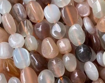 May include: A strand of sunstone beads in various shades of brown, orange, and white. The beads are oval shaped and have a smooth, polished finish.