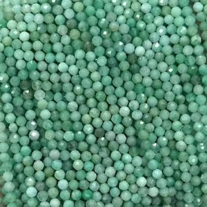 May include: A strand of green gemstone beads, likely emerald, with a faceted finish. The beads are small and uniform in size, creating a delicate and elegant look.