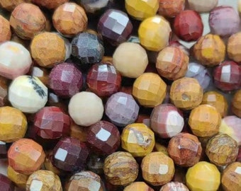May include: A strand of faceted gemstone beads in shades of red, brown, yellow, and white. The beads are all approximately the same size and have a smooth, polished finish.