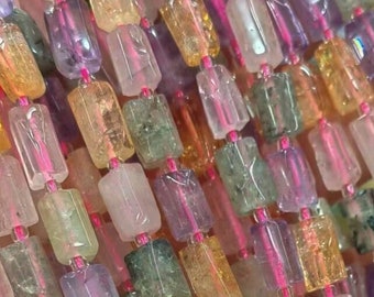 May include: A strand of multi-colored gemstone beads. The beads are rectangular and have a variety of colors, including pink, purple, green, and yellow. The beads are strung on a clear elastic cord.