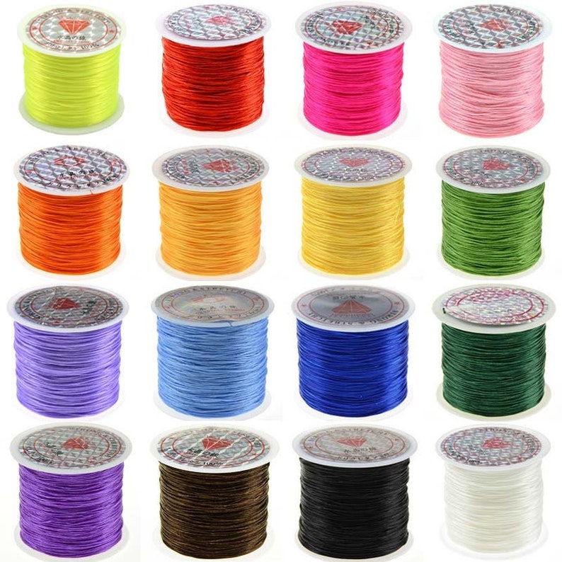 May include: Assortment of 16 spools of elastic string in various colors, including yellow, red, pink, orange, light orange, yellow, green, light purple, blue, dark blue, green, purple, brown, black, and white.