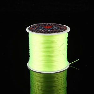 May include: A spool of bright green glow-in-the-dark fishing line.