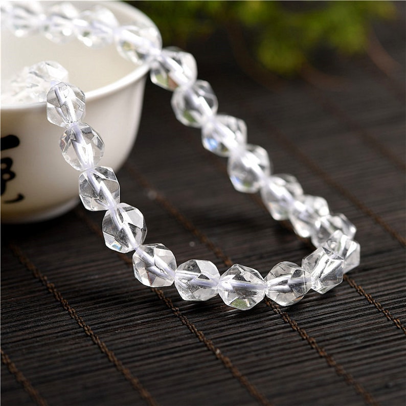 May include: A clear crystal bracelet with faceted beads. The bracelet is made of natural quartz and is strung on a clear elastic cord.