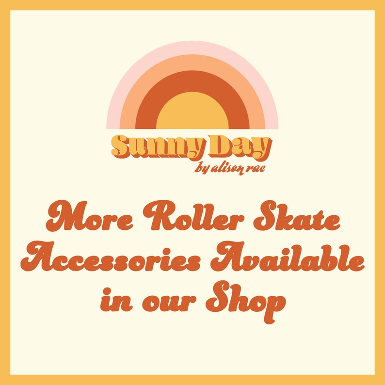 Op de afbeelding: Een afbeelding met een regenboogvormige boog en de tekst "Sunny Day by alison rae". Onder de tekst staat de zin "More Roller Skate Accessories Available in our Shop" in een retro-lettertype.