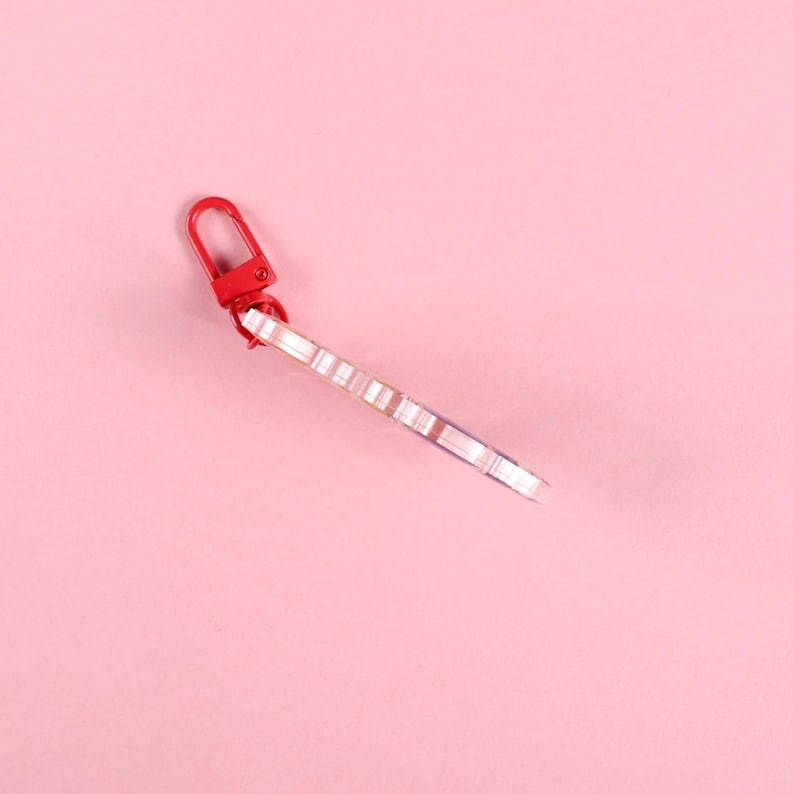 May include: A white ceramic mug with a black handle and the text "But First, Coffee" in a bold, black font. The mug is set against a blurred background, suggesting a cozy setting. The mug appears to be approximately 4 inches tall.