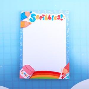 May include: A rectangular notepad with a white center and a light blue border featuring small white icons. The top displays the word Scribbles in blue and red, flanked by blue and orange pencils. A pink eraser and a red pencil are at the bottom.
