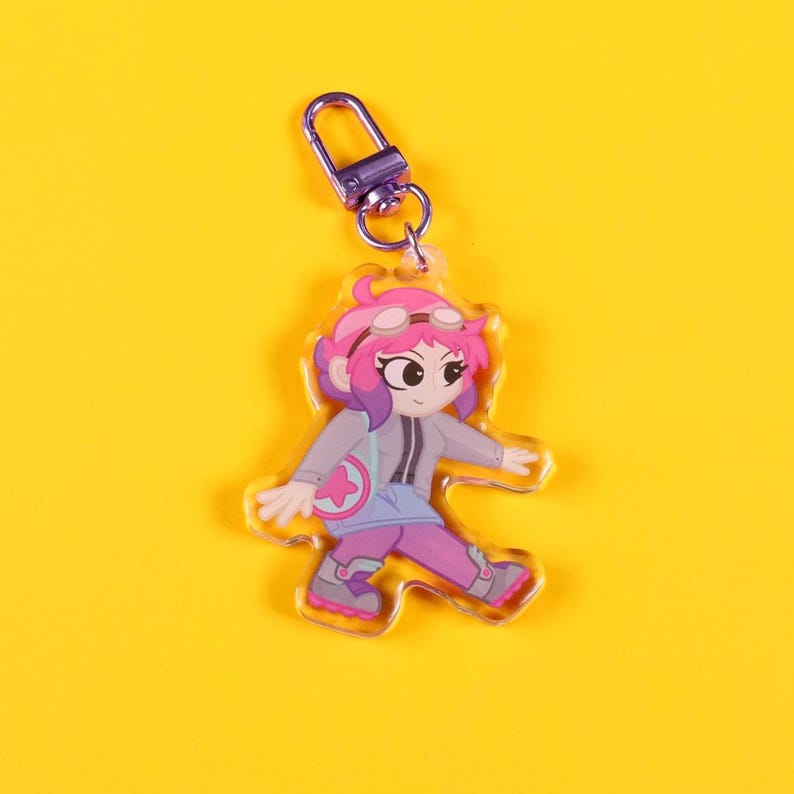 May include: A set of three ceramic mugs with a speckled, cream-colored glaze. Each mug features a different hand-painted design: a blue and green leaf, a yellow flower, and a red berry. The mugs have a simple, modern design.