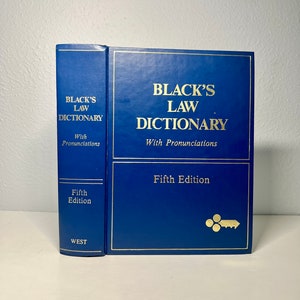 Pode incluir: Um livro azul de capa dura intitulado "Black's Law Dictionary" com letras e detalhes dourados. O livro é uma quinta edição e inclui pronúncias. A lombada também mostra o título e a edição.