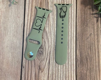 May include: Two green silicone watch bands with black designs. One band has a heart beat with a heart symbol and the other has a stethoscope with a heart symbol.