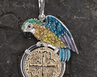 May include: A silver parrot pendant with blue, green, and yellow enamel. The parrot is perched on a gold-colored coin with a cross design.