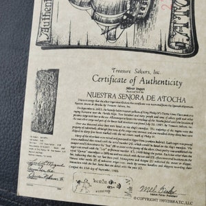 May include: A certificate of authenticity for a silver ingot recovered from the Nuestra Se&ntilde;ora de Atocha shipwreck. The certificate is dated September 15th, 1986, and includes the text "Nuestra Se&ntilde;ora de Atocha" and "Treasure Salvors, Inc."