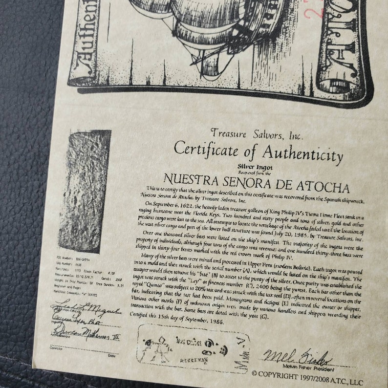 May include: A certificate of authenticity for a silver ingot recovered from the Nuestra Se&ntilde;ora de Atocha shipwreck. The certificate is dated September 15th, 1986, and includes the text "Nuestra Se&ntilde;ora de Atocha" and "Treasure Salvors, Inc."