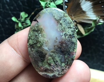 May include: Oval shaped green, brown, and white agate cabochon with a mossy pattern.