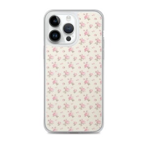 May include: Clear phone case with a floral pattern. The design features small pink roses scattered across a cream-colored background. The case has a transparent border, showcasing the phone's design.