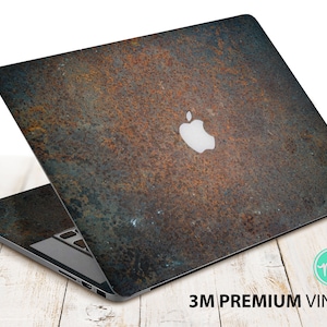 Puede incluir: Un ordenador portátil con una piel de diseño de metal oxidado. El portátil tiene un logotipo de Apple blanco en la tapa. La piel está hecha con vinilo 3M de primera calidad.