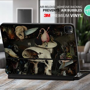Peut inclure: Une coque noire pour iPad avec une image colorée et détaillée d'une peinture. La coque porte le logo 3M et le texte "Air-Release Adhesive Backing Prevents Air Bubbles 3M Premium Vinyl".