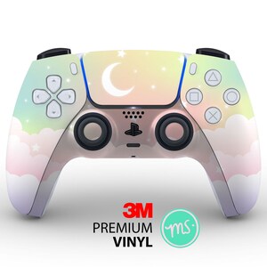 May include: A pastel pink, yellow, and blue PlayStation 5 controller with a crescent moon and stars design. The controller is made of high-quality vinyl and is compatible with the PlayStation 5 console.