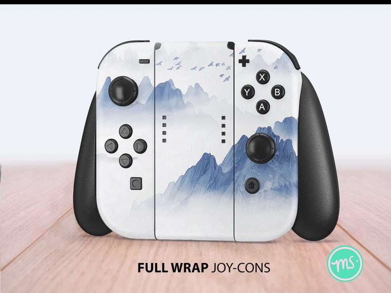 May include: A white Nintendo Switch Joy-Con controller with a blue and white mountain landscape design. The controller has black buttons and a black grip.