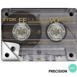 May include: A clear plastic cassette tape with a black label. The label reads "TDK EE FERRIC 90 IECI TYPEI NORMAL POSITION LOW NOISE HIGH OUTPUT".