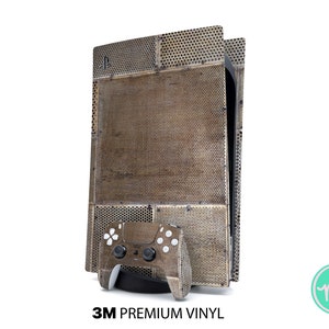 Könnte beinhalten: Eine braune und goldene Vinyl-Haut für eine Spielekonsole. Die Haut hat eine strukturierte, metallische Optik. Eine passende Controller-Haut ist ebenfalls enthalten.