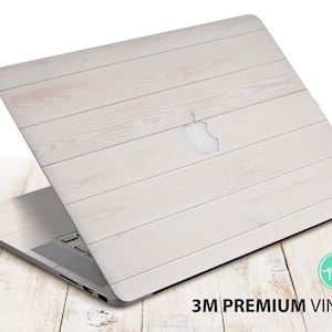 May include: White wood grain laptop skin with the Apple logo. 3M Premium Vinyl.