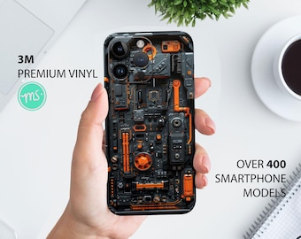 May include: A black and orange phone case with a circuit board design. The case has a 3M logo and the text "Premium Vinyl".