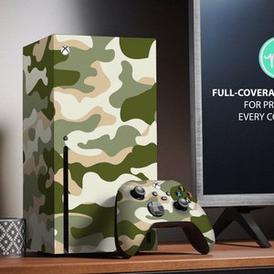 May include: A camouflage-patterned skin for a gaming console, with a matching camouflage-patterned controller. The skin is a full-coverage kit that protects every corner of the console. The text "FULL-COVERAGE KIT FOR PROTECT EVERY CORNER" is visible on the image.