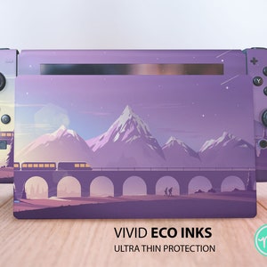 May include: Purple and white Nintendo Switch console skin with a mountain range and train on a bridge design. The text "VIVID ECO INKS ULTRA THIN PROTECTION" is printed below the image.