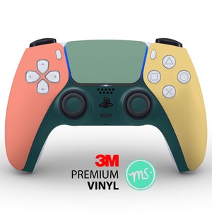 Könnte beinhalten: Ein grüner, gelber und orangefarbener PlayStation 5 DualSense-Controller mit dem Text 3M Premium Vinyl und einem kleinen Kreis mit den Buchstaben "ms" darin.