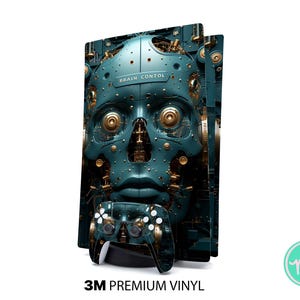 May include: A teal and gold PlayStation 5 console skin and controller featuring a robotic face design with the text "BRAIN CONTOL". The skin is made of 3M premium vinyl.