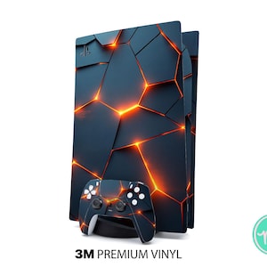 May include: A black and orange geometric design covers a gaming console and controller. The console has a dark blue background with orange lines. The controller has a matching design with white buttons. The text "3M PREMIUM VINYL" is at the bottom.