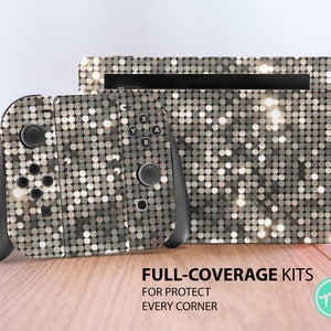 May include: A silver and black Nintendo Switch console and controller with a sparkly, silver, and black, disco ball-like design. The text "FULL-COVERAGE KITS FOR PROTECT EVERY CORNER" is printed below the console and controller. The text "ms" is printed in a circle below the text.