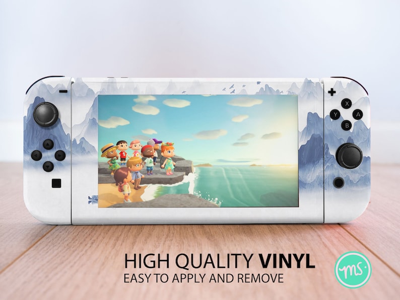 May include: White Nintendo Switch console skin with a blue and white watercolor mountain landscape design. The screen shows a video game scene with characters standing on a cliff overlooking the ocean. The text "HIGH QUALITY VINYL EASY TO APPLY AND REMOVE" is printed below the console.